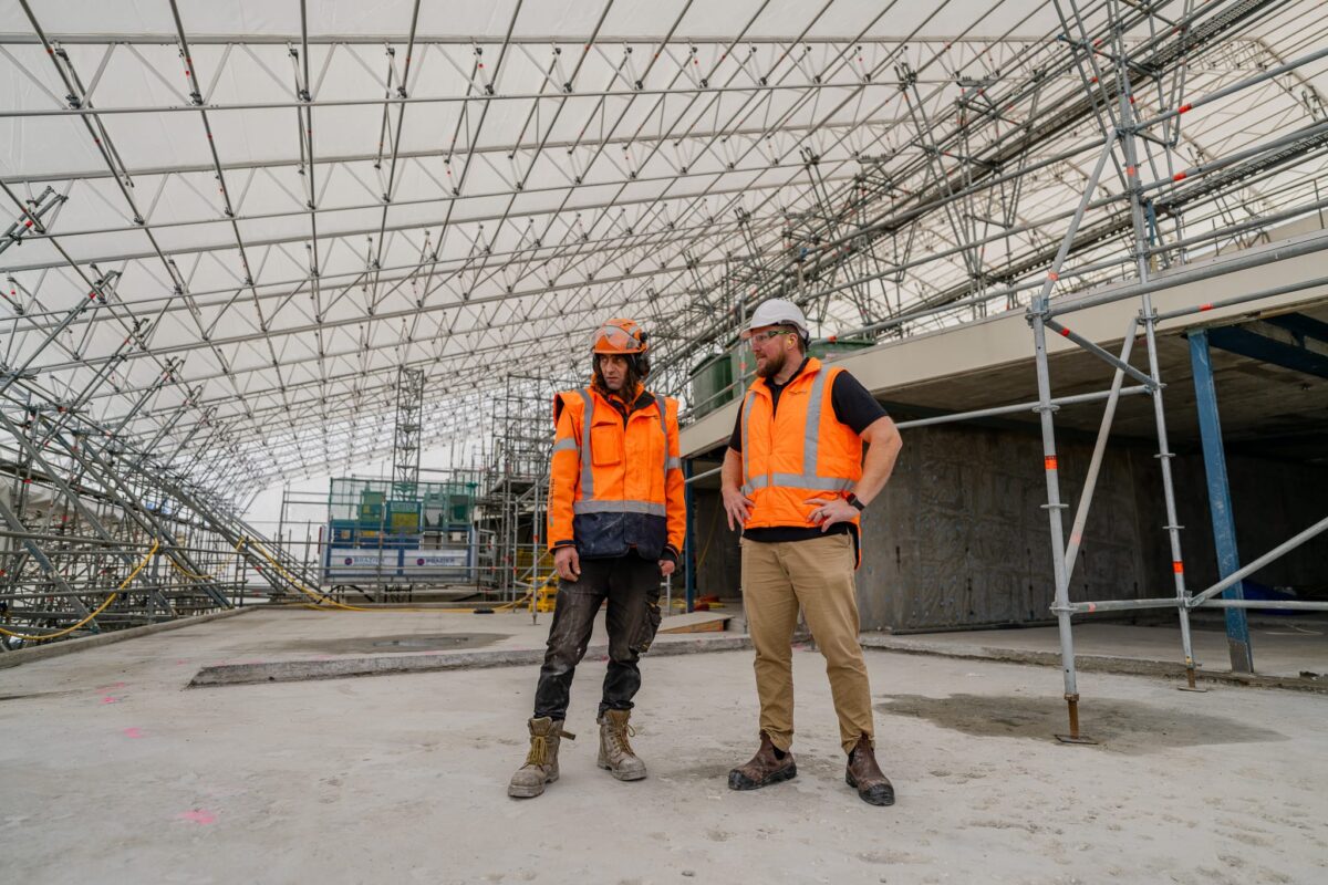 image of Scope Group employees discussing Queenstown Club Suites demolition & civil contracting project in New Zealand's South Island