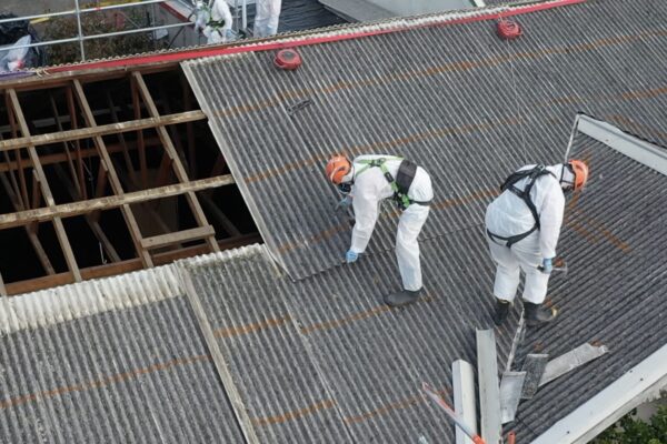 image of Scope Group workers on roof of commercial property wearing PPE for asbestos removal and demolition services in New Zealand