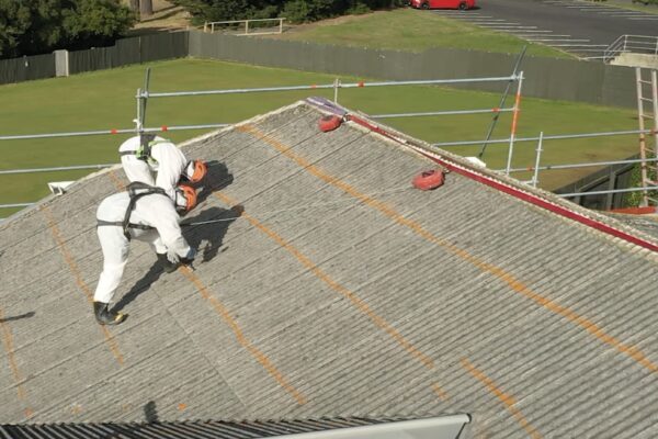 image of Scope Group workers on roof of commercial property wearing PPE for asbestos removal and demolition services in New Zealand