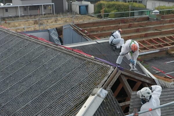 image of Scope Group workers on roof of commercial property wearing PPE for asbestos removal and demolition services in New Zealand