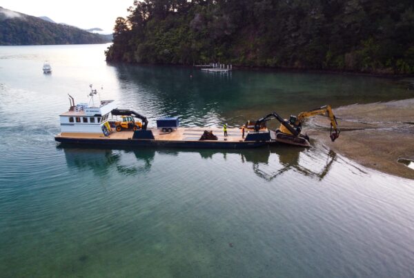 image of Scope Group excavation machinery being delivered by boat at demolition and deconstruction project at Becks Bay, Marlborough, NZ