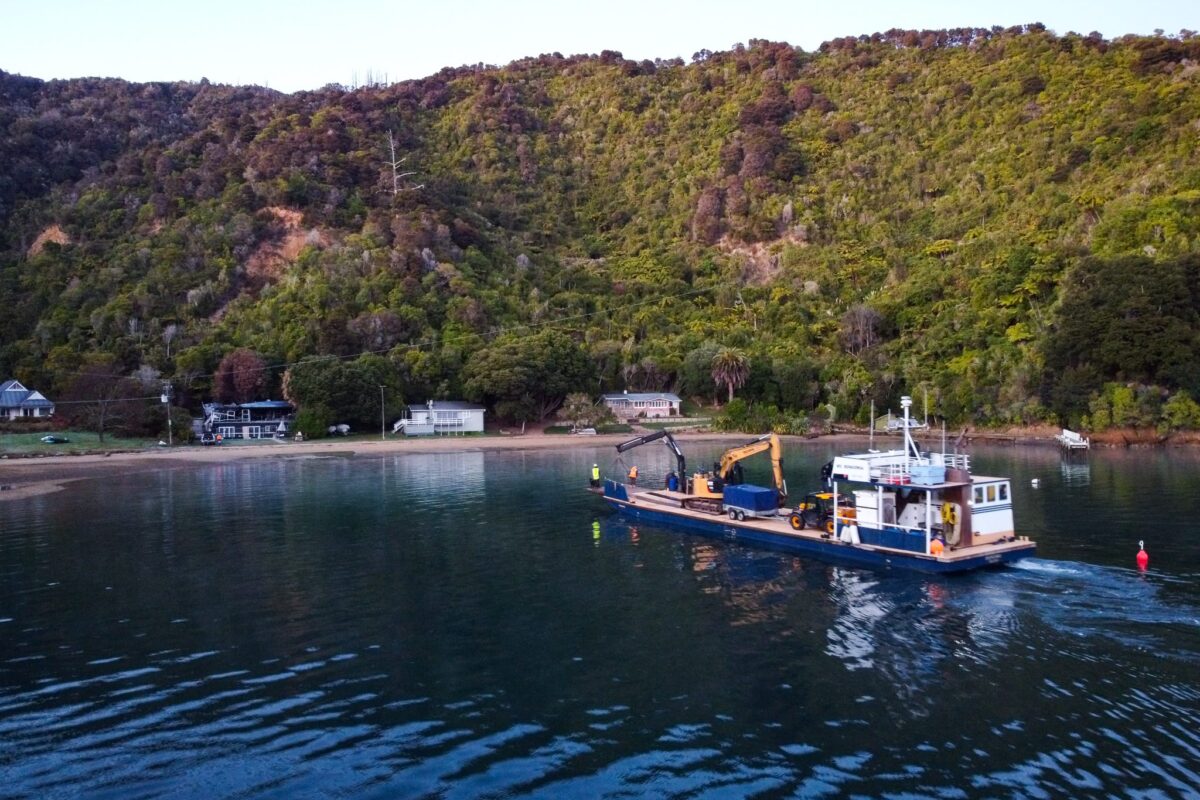 image of Scope Group excavation machinery being delivered by boat at demolition and deconstruction project at Becks Bay, Marlborough, NZ