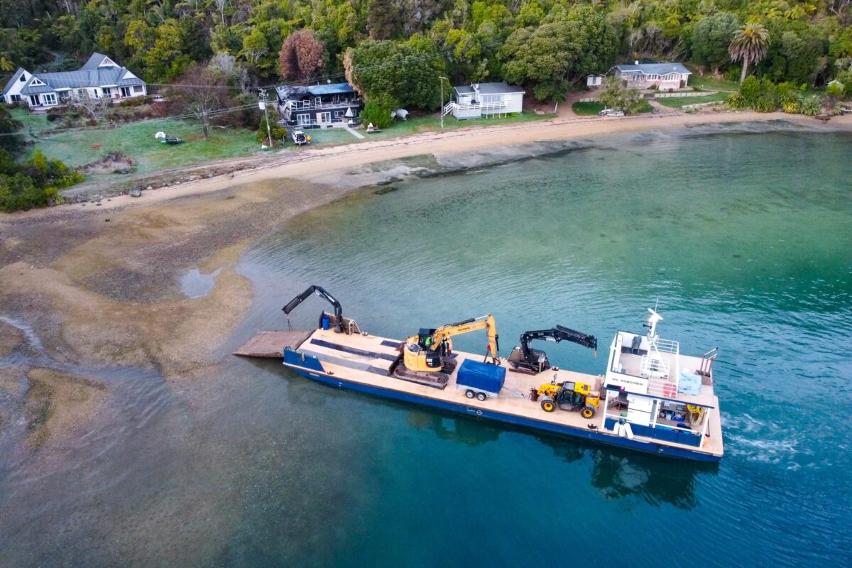 image of Scope Group excavation machinery being delivered by boat at demolition and deconstruction project at Becks Bay, Marlborough, NZ