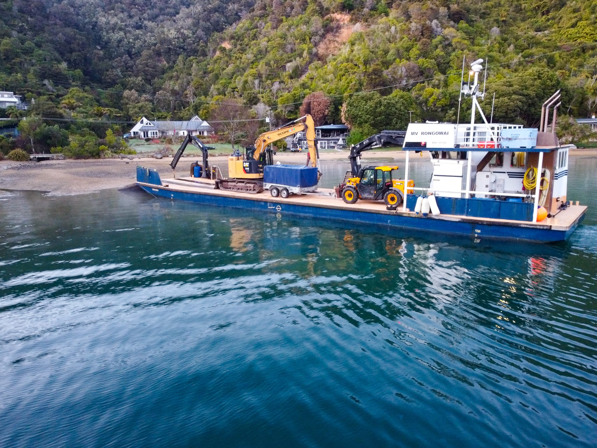 image of Scope Group excavation machinery being delivered by boat at demolition and deconstruction project at Becks Bay, Marlborough, NZ