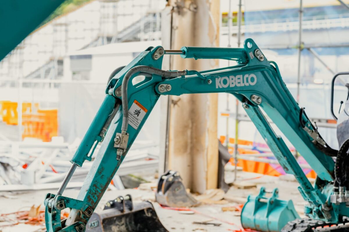 image of small excavator inside Picton terminal being demolished and stripped out by Scope Group, NZ