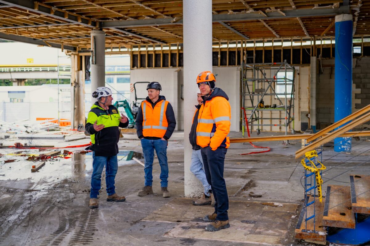 image of Scope Group workers standing together and discussing demolition and strip out project in front of them in Picton, New Zealand